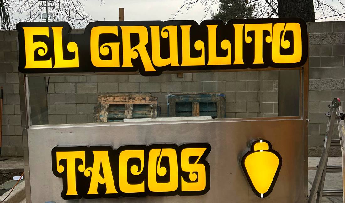 El Grullito illuminated taco cart signage