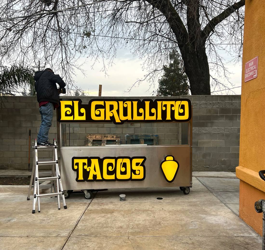 Installing El Grullito taco cart light-up letters