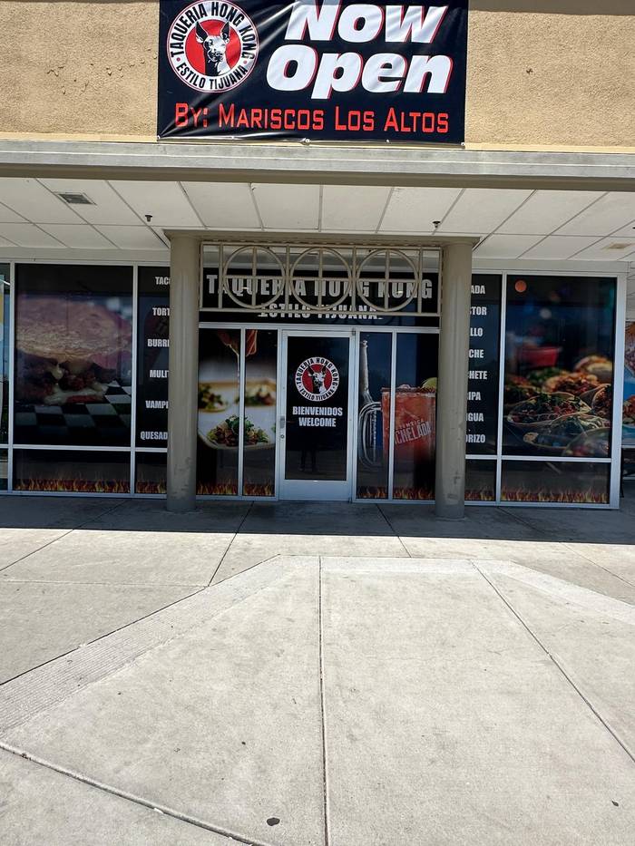 Grand-opening vinyl banner installed on storefront