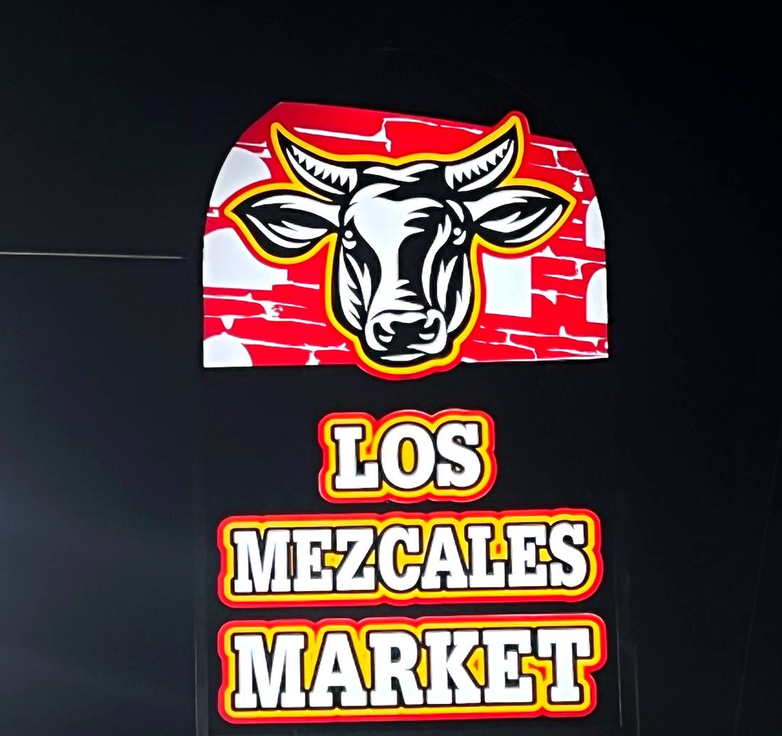 Los Mezcales Market pylon sign at night